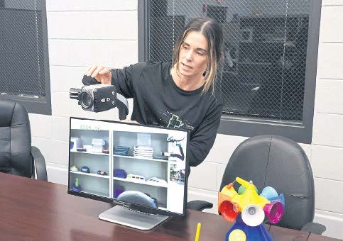 Kassandra Hester, assistive technology assistant, demonstrates how an Enhanced Vision device operates for someone who has low vision on May 12 at Wendell Foster’s Assistive Technology and Resource Center