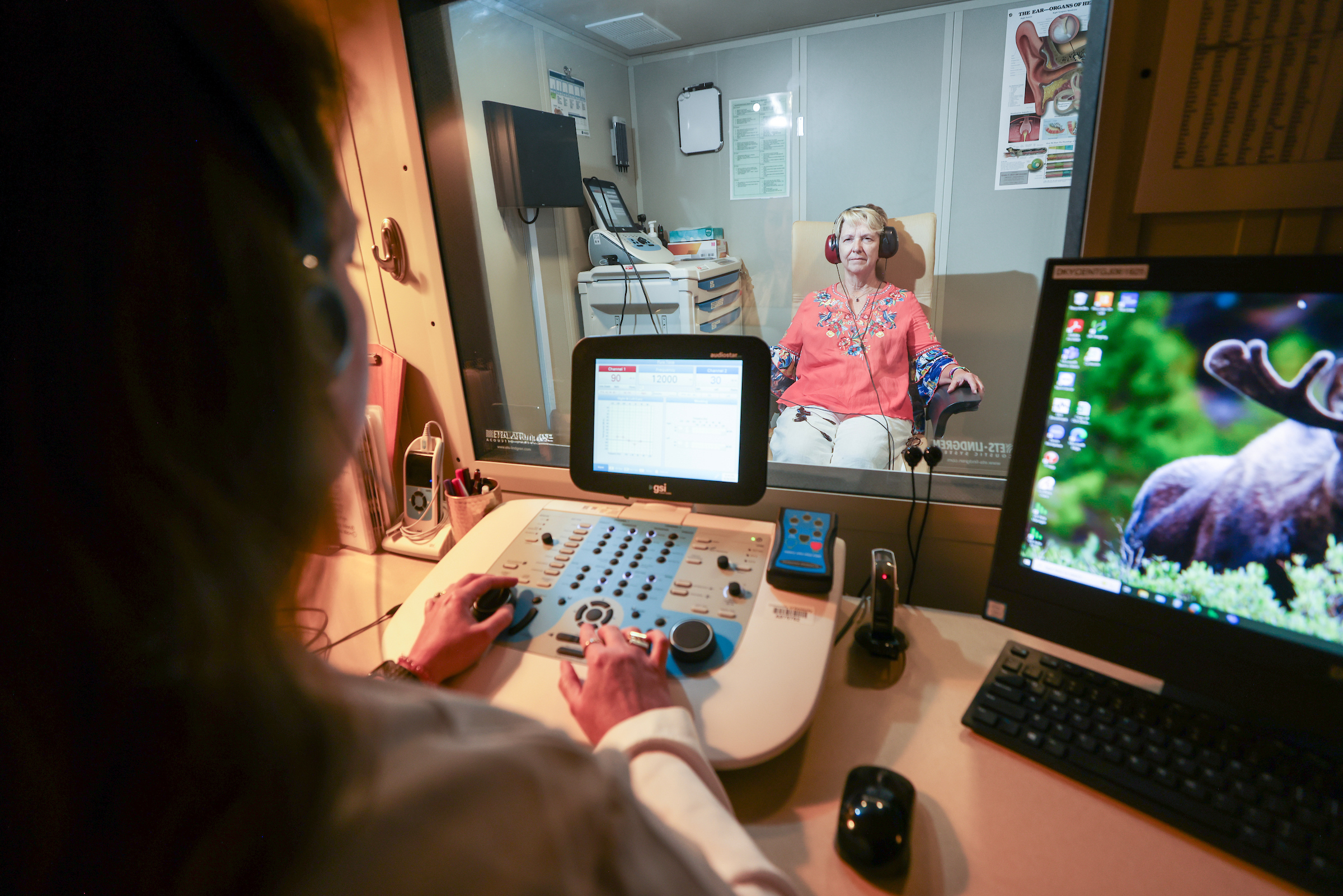 Audiologist working with patient