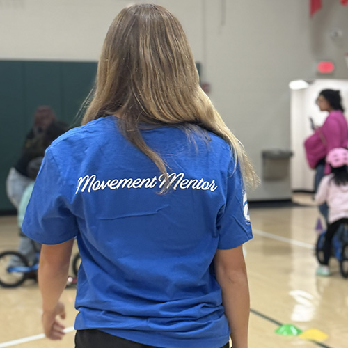 Woman wearing movement mentors shirt