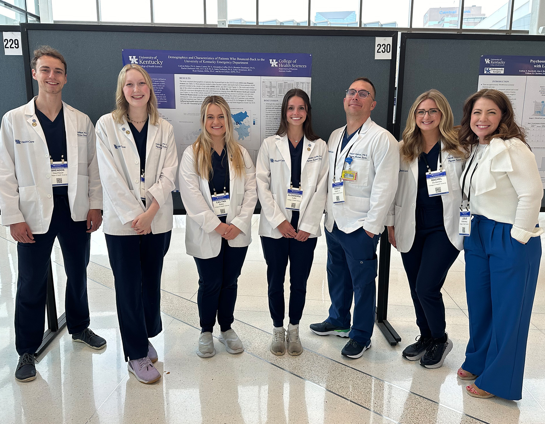 PAS students in front of a research poster
