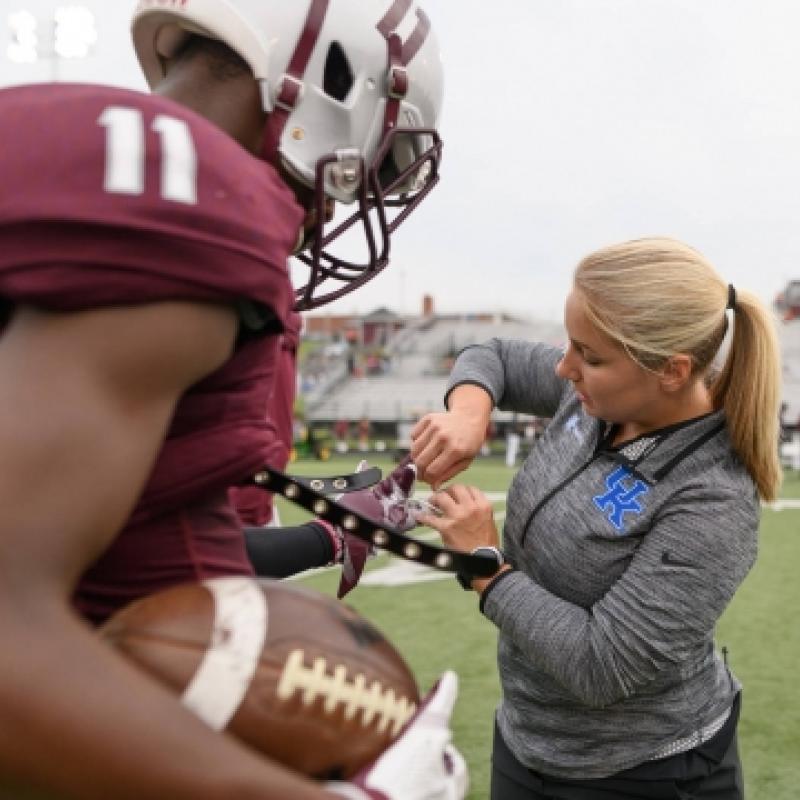 Athletic Trainer with High School football player