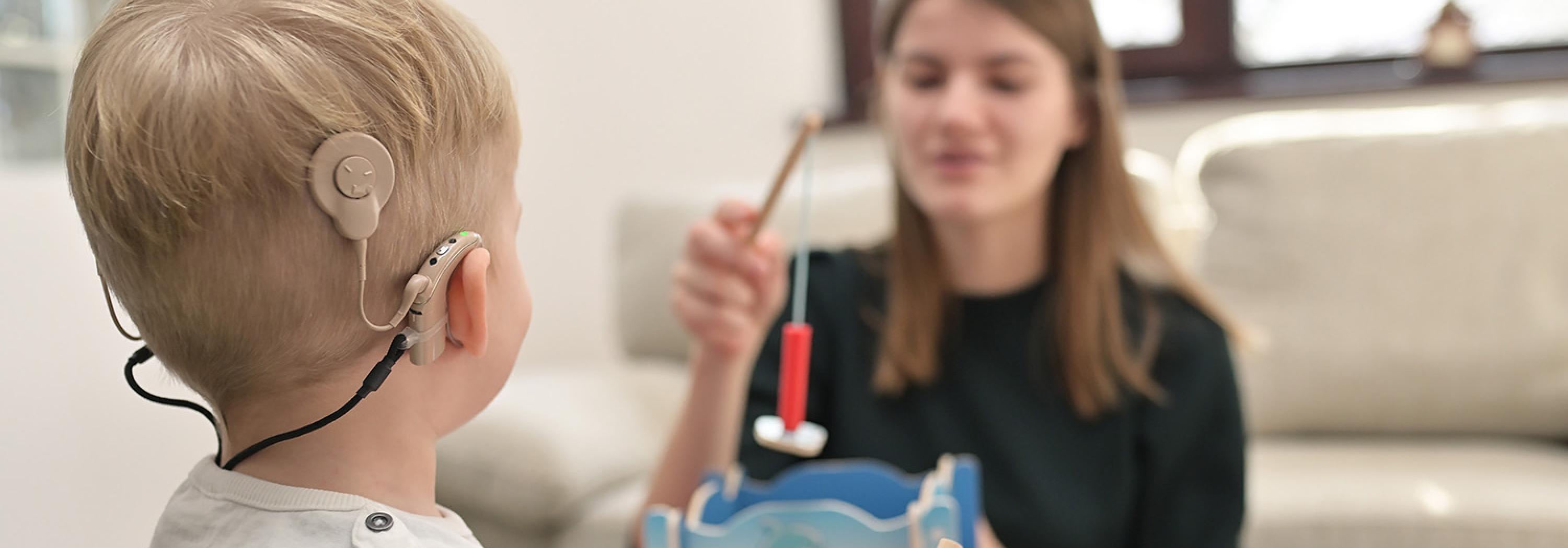Audiologist working with pediatric patient