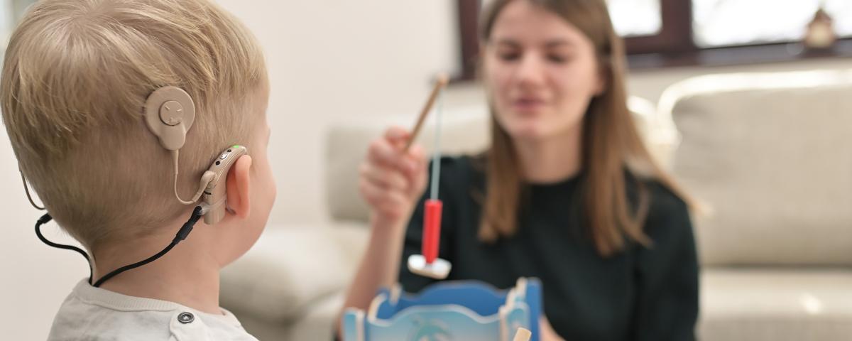 Audiologist working with child patient