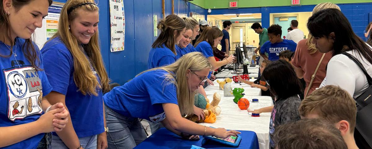 AAC Lab members working with students at an elementary school