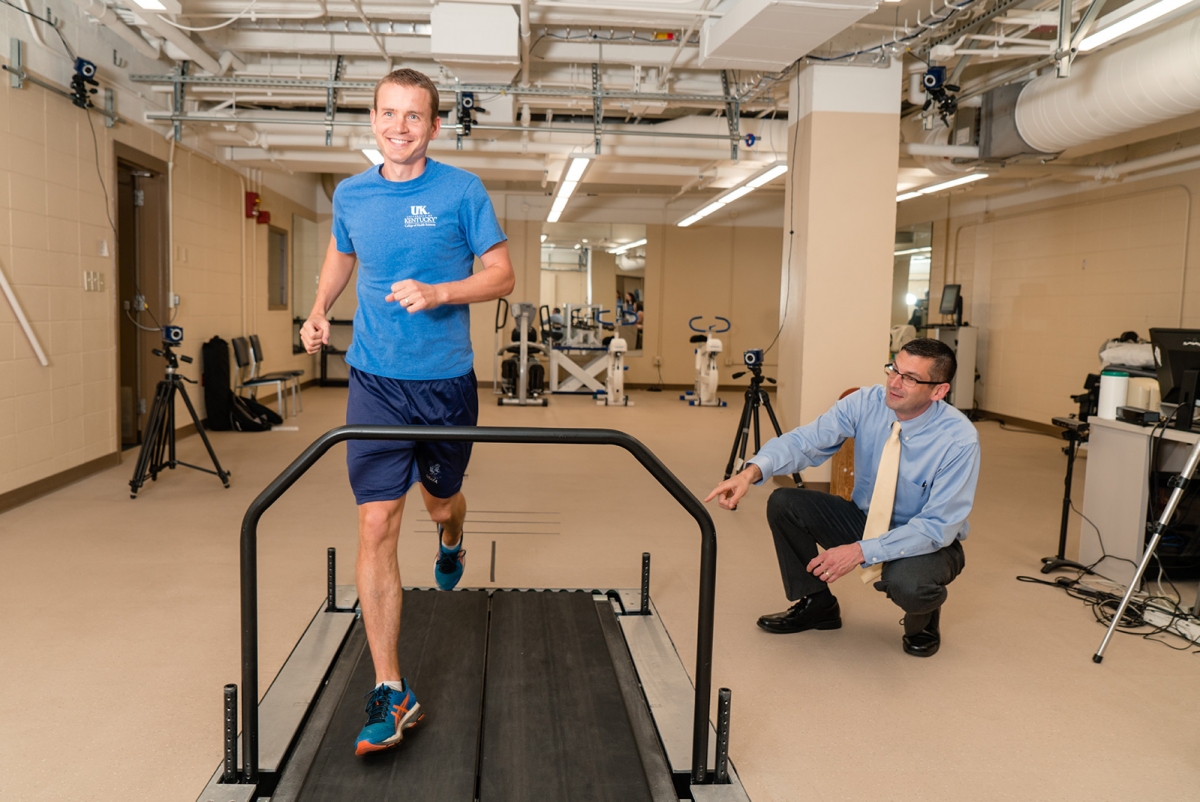 Researcher analyzing patient running on a treadmill