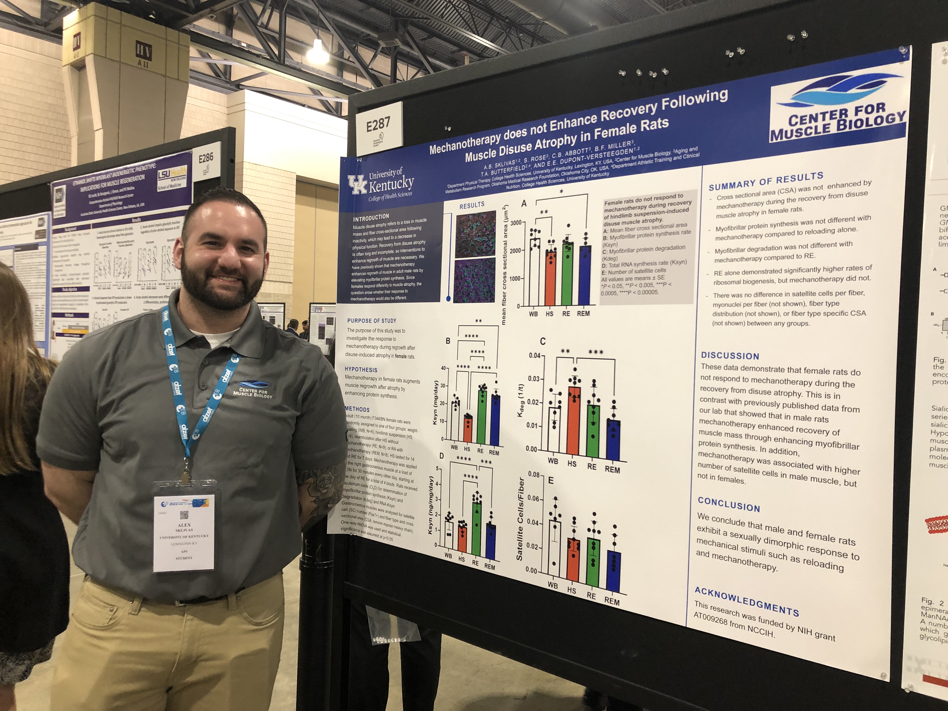 Alexander Sklivas in front of research poster